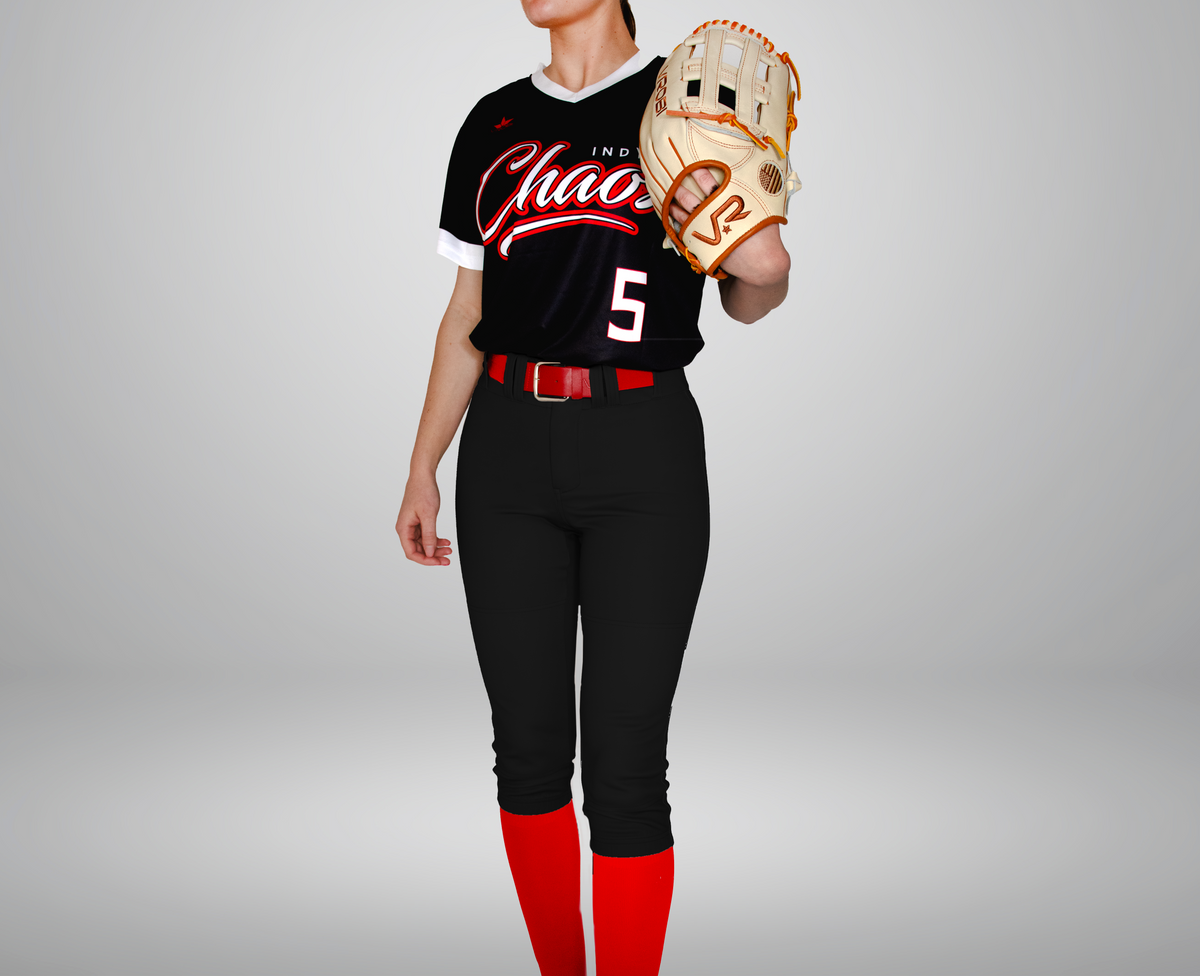 A softball player wearing black softball pants, red socks, and a red belt holding a brown glove.
