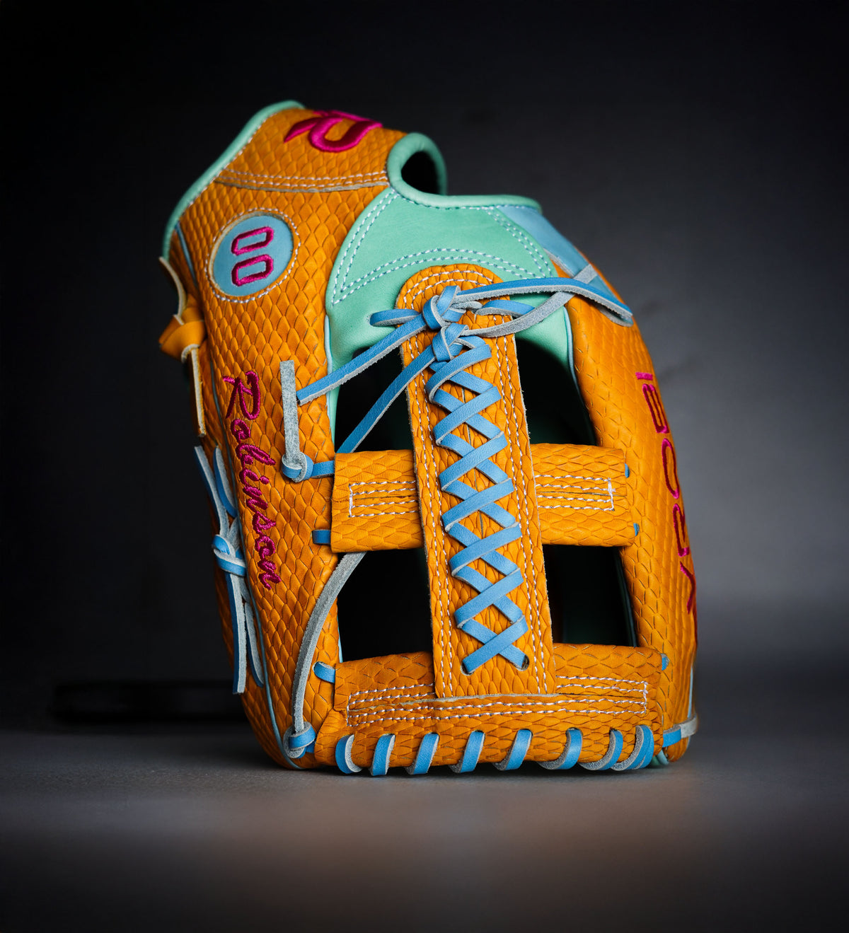 A Vrobi Custom Snakeskin yellow, mint, sky blue, and pink custom baseball/softball glove