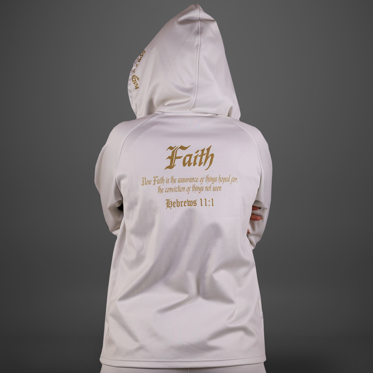 White hoodie with 'Faith' text on the back against a gray background