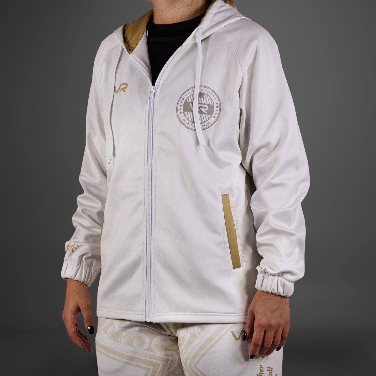 White tracksuit with gold accents on a gray background